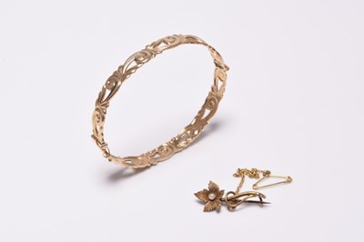 Lot 296 - A 9ct gold bangle and a seed pearl brooch