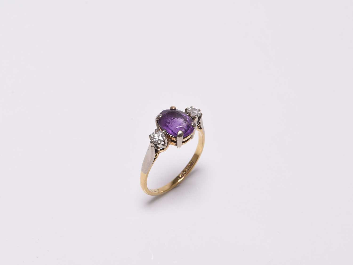 Lot 366 - A three stone amethyst and diamond ring