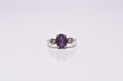 Lot 366 - A three stone amethyst and diamond ring
