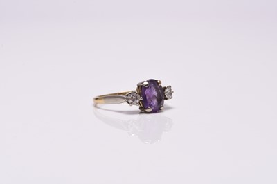 Lot 366 - A three stone amethyst and diamond ring