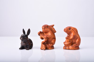 Lot 225 - A group of three Japanese wood netsuke of rabbits, 20th century