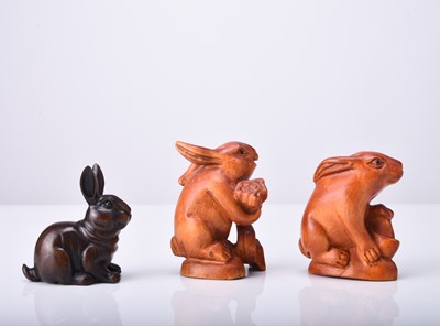 Lot 225 - A group of three Japanese wood netsuke of rabbits, 20th century