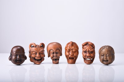 Lot 233 - A group of six Japanese wood netsuke of masks, 20th century