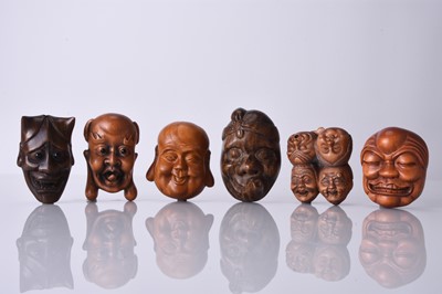 Lot 235 - A group of six Japanese wood netsuke of masks, 20th century