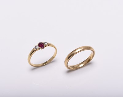 Lot 277 - An 18ct gold wedding band and an 18ct gold ruby and diamond ring