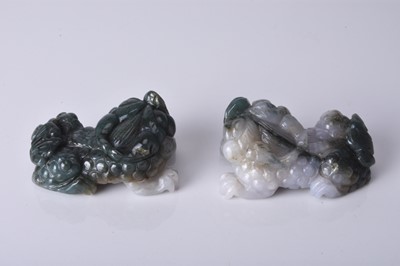 Lot 161 - A pair of Chinese jadeite figures of lion dogs, 20th century