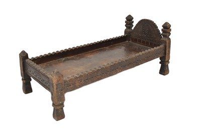 Lot 175 - A carved hardwood prayer bed/table, North Pakistan, 19th century