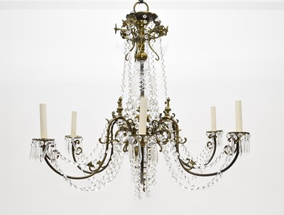 Lot 218 - A large six-branch brass and glass chandelier