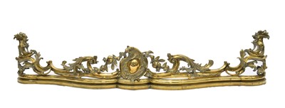 Lot 204 - A Rococo revival brass fire fender, late 19th century