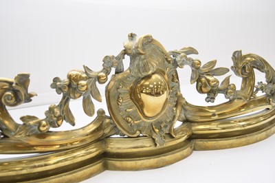 Lot 204 - A Rococo revival brass fire fender, late 19th century