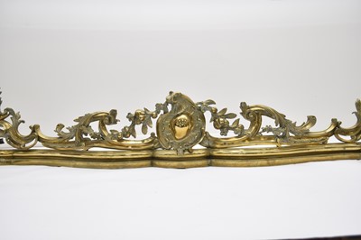 Lot 204 - A Rococo revival brass fire fender, late 19th century