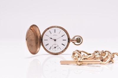 Lot 88 - Waltham: A gold hunter pocket watch with gold Albert chain