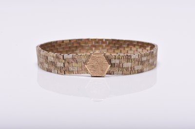 Lot 302 - A 9ct tri-coloured gold textured brick link bracelet