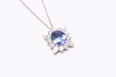 Lot 38 - A sapphire and diamond cluster pendant