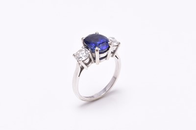 Lot 39 - An 18ct white gold three stone sapphire and diamond ring