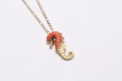 Lot 320 - A coral and sapphire set seahorse pendant on chain