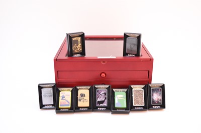 Lot 537 - A collection of 91 DeAgostini Zippo lighters and a display case