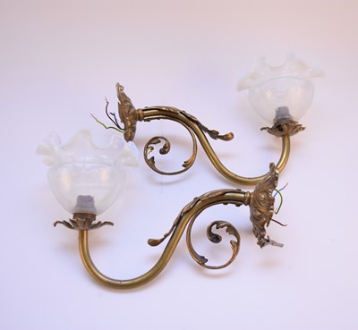 Lot 609 - Pair of gilt metal wall sconces with glass shades