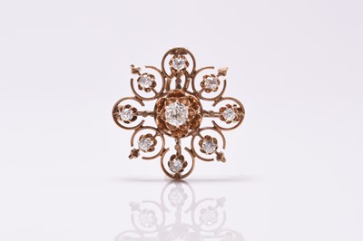 Lot 68 - A diamond set circular openwork brooch / pendant