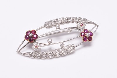 Lot 75 - An early 20th century diamond and ruby set openwork brooch