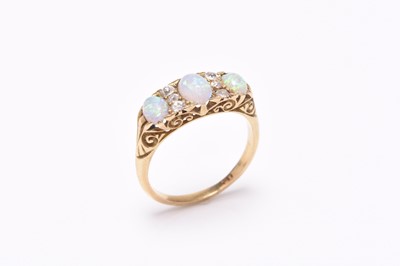 Lot 79 - A late 19th century nine stone opal and diamond ring