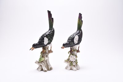 Lot 222 - Two similar German porcelain models of magpies on tree stumps, late 19th century