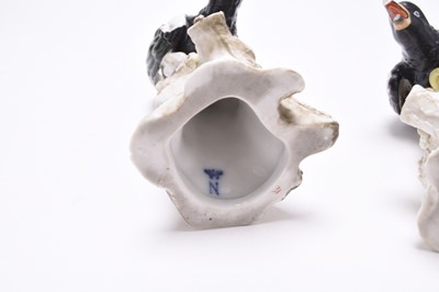 Lot 222 - Two similar German porcelain models of magpies on tree stumps, late 19th century