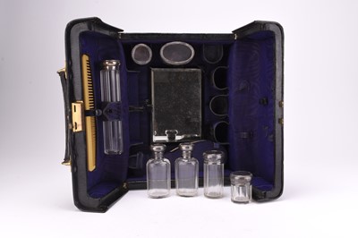 Lot 53 - A cased silver mounted travelling dressing table set