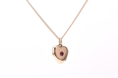 Lot 151 - A 9ct gold ruby set heart shaped pendant locket on chain