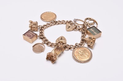 Lot 64 - A 9ct gold flat curb link bracelet with attached charms