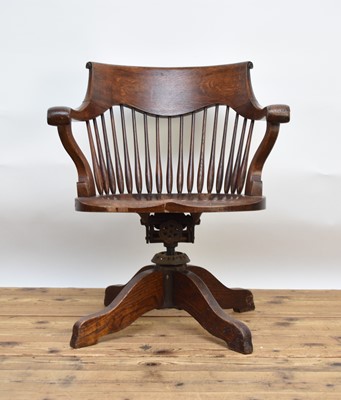 Lot 501 - An early 20th century oak office chair