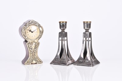 Lot 237 - A pair of WMF style candle holders and a silver-mounted mantel or desk clock