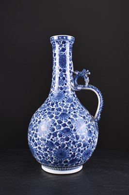 Lot 32 - A Chinese soft paste blue and white dragon ewer, 18th century