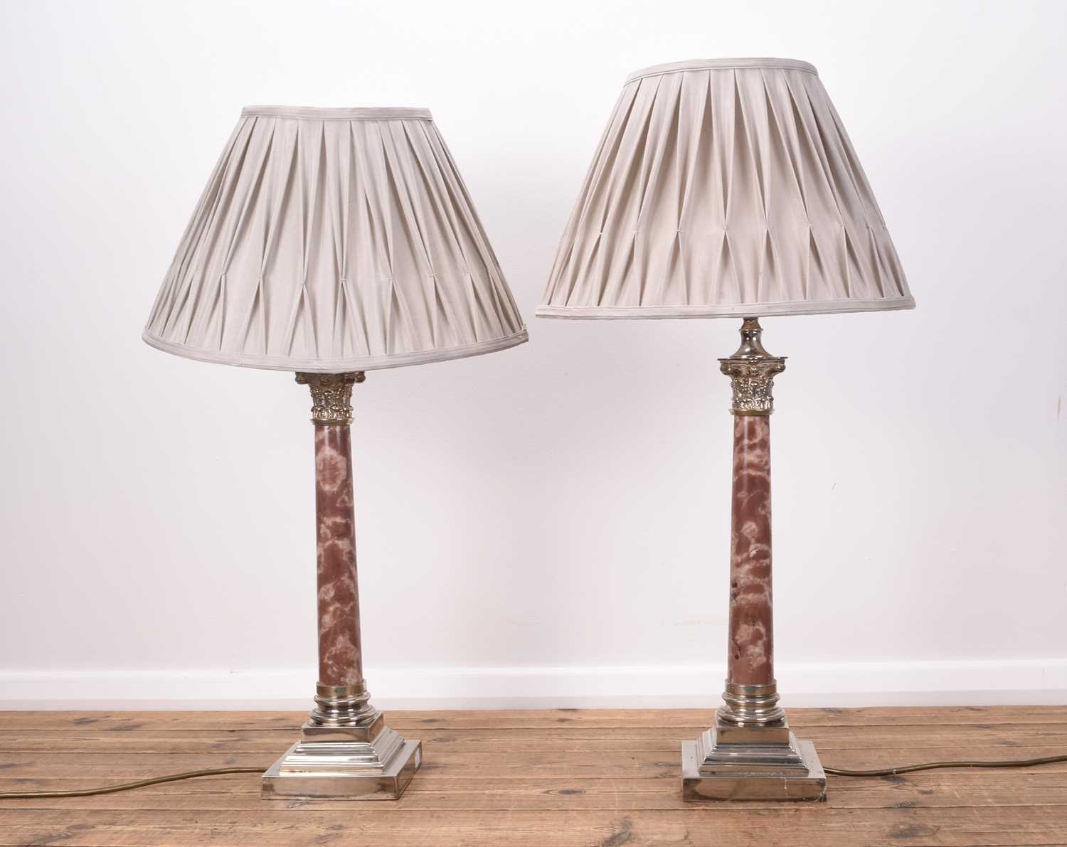 Lot 384 - A pair of electroplate and variegated pink marble Corinthian column table lamps