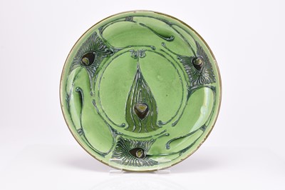 Lot 50 - Art Nouveau CH Brannam 'Peacock' feather charger and a 'Fish' vase