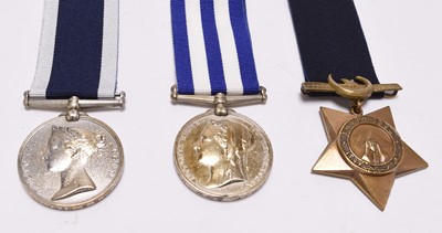 Lot 127 - A Victorian group of three Royal Navy / Coastguard medals, including Egypt 1882, with paperwork
