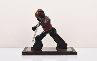 Lot 240 - An Art Deco style carved wood and composite figure of a striding man