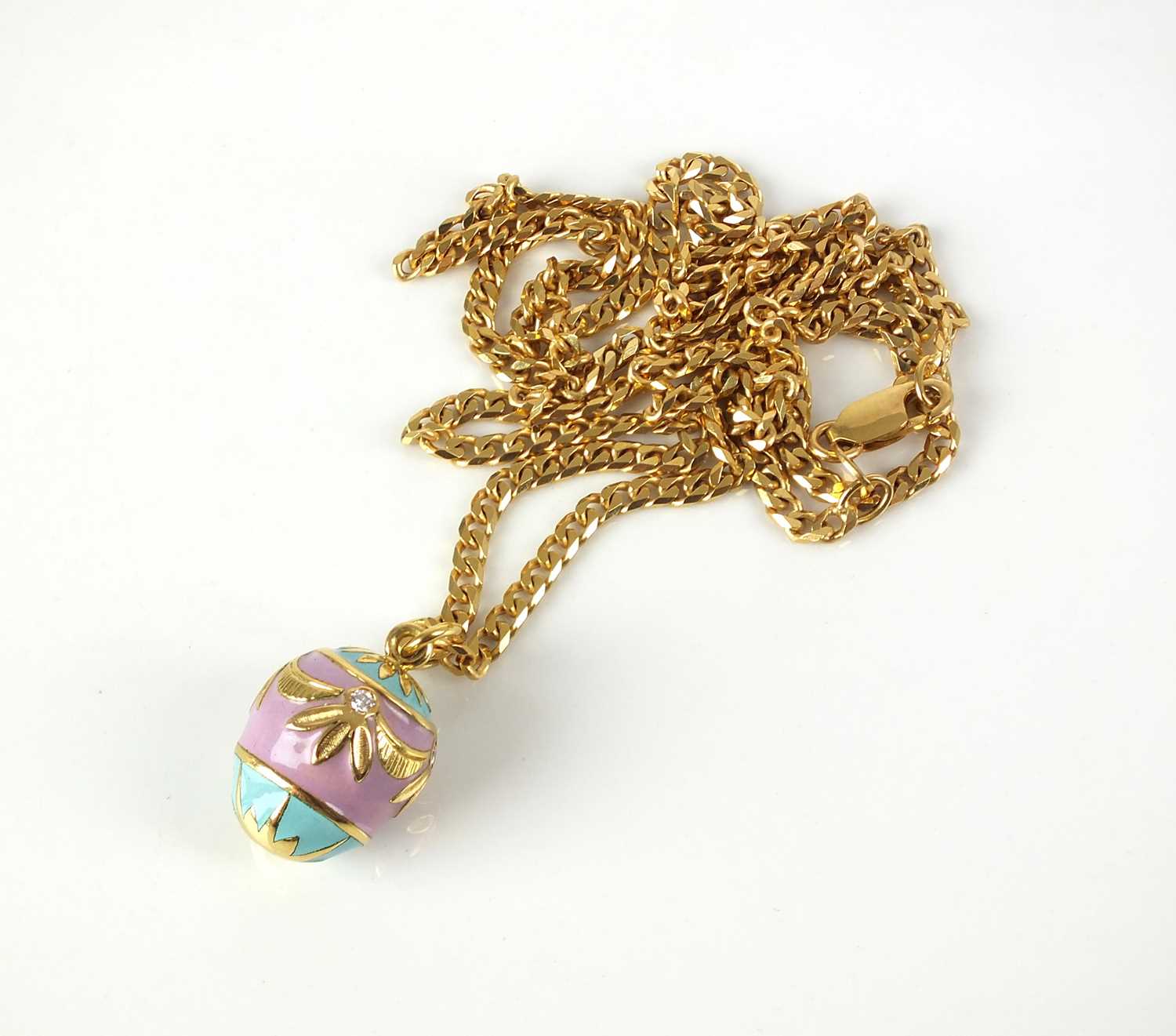 Lot 24 - A diamond and enamel egg pendant on chain