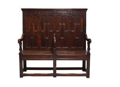 Lot 390 - An 18th century and later oak settle with geometric back