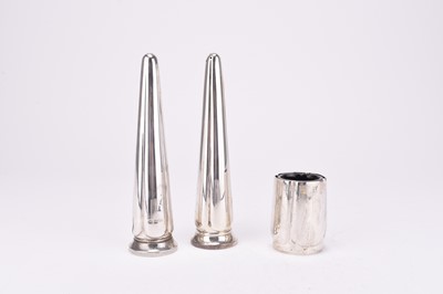 Lot 28 - A pair of silver salt and pepper shakers of lobed conical form and a silver mustard pot