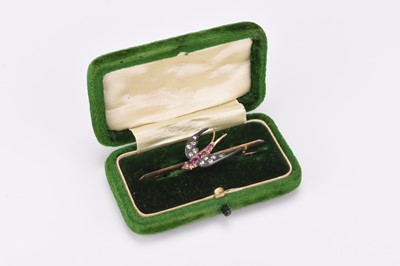 Lot 202 - A late 19th / early 20th century rose cut diamond and synthetic ruby swallow bar brooch