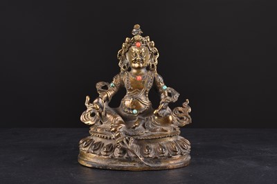 Lot 99 - A Sino-Tibetan gilt-bronze figure of Jambhala