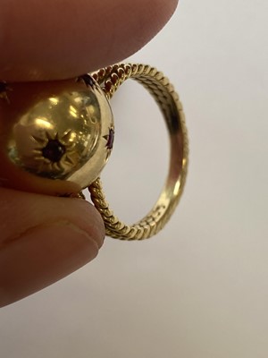Lot 50 - A pair of ruby set orb rings