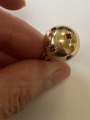 Lot 50 - A pair of ruby set orb rings