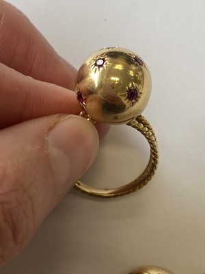 Lot 50 - A pair of ruby set orb rings