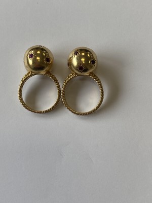 Lot 50 - A pair of ruby set orb rings