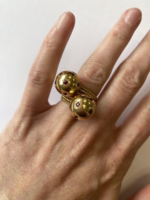 Lot 50 - A pair of ruby set orb rings