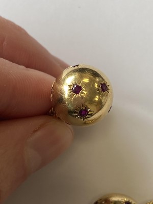 Lot 50 - A pair of ruby set orb rings