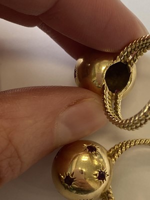 Lot 50 - A pair of ruby set orb rings