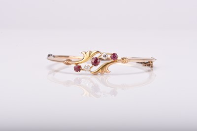 Lot 284 - An early 20th century untested ruby and diamond bangle